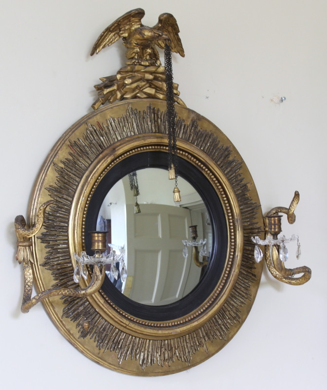 Appraisal: A Regency gilt framed convex girandole mirror with eagle surmount