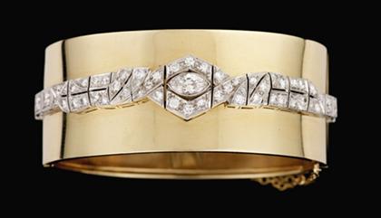 Appraisal: Platinum yellow gold and diamond bangle bracelet Unusual platinum line