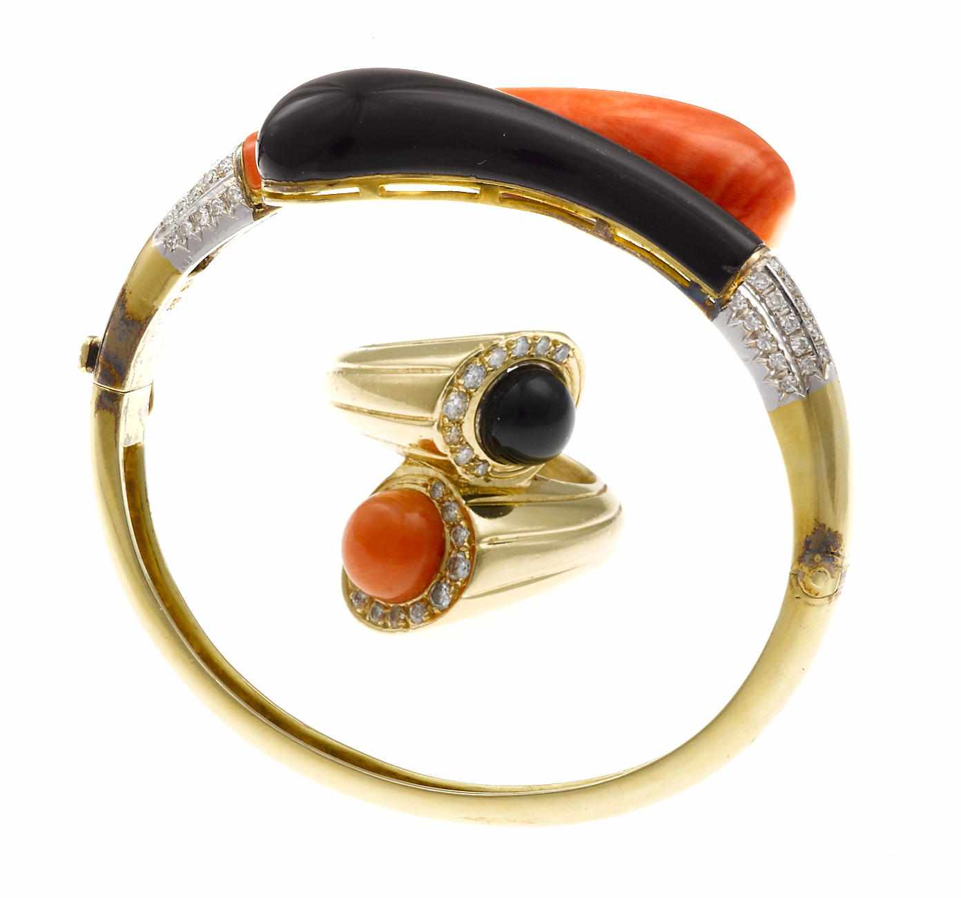 Appraisal: A coral and black onyx bypass style bangle bracelet together