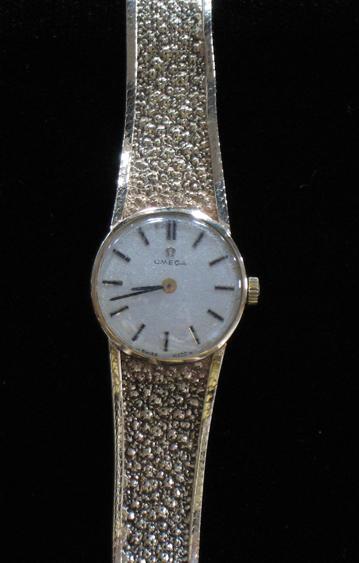 Appraisal: A LADY'S OMEGA WRISTWATCH the white dial with raised batten