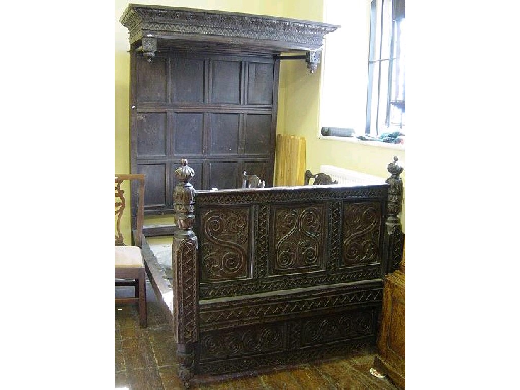 Appraisal: An antique oak half tester bedstead with raised panelled back