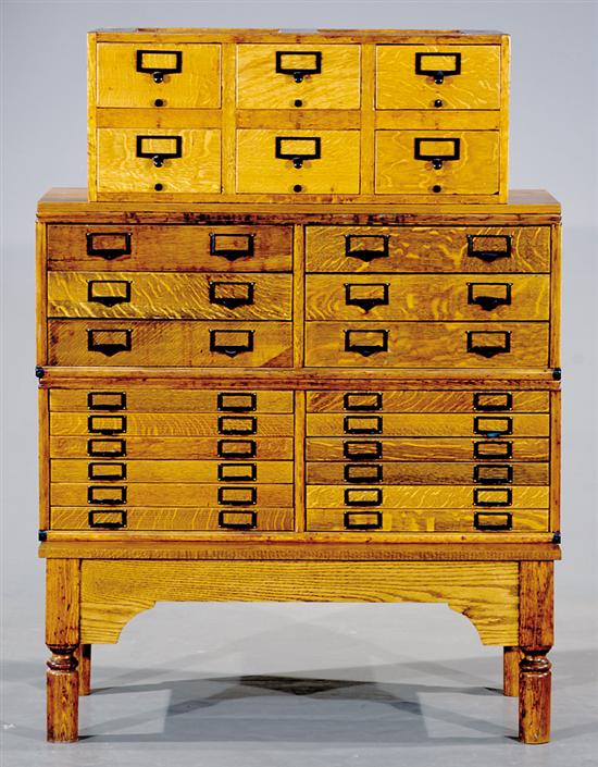 Appraisal: Stacking oak file drawers on stand cases containing small drawers