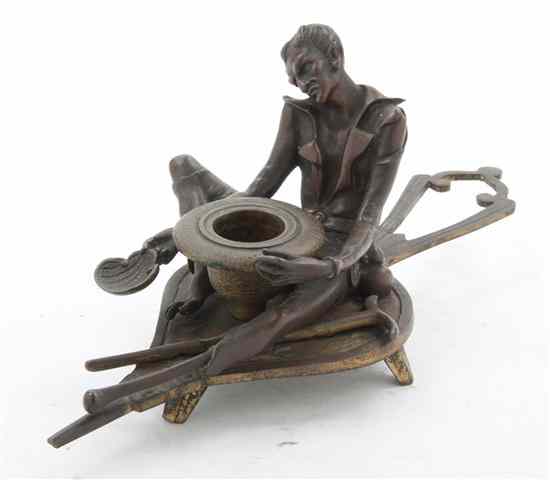 Appraisal: A Figural Chamberstick depicting a seated demon with a leaf