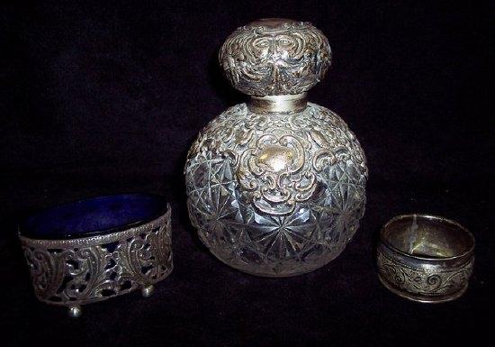 Appraisal: A cut glass scent bottle with embossed silver mounts an