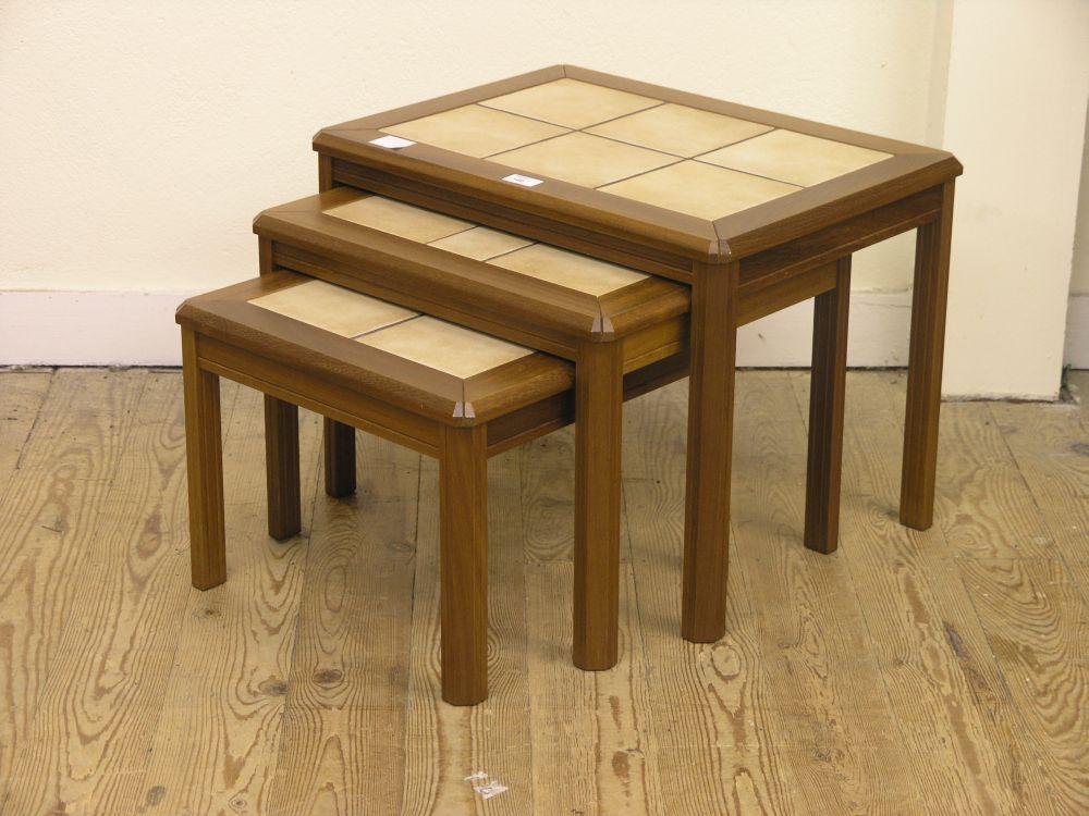 Appraisal: A modern teak nest of three tables each with inset