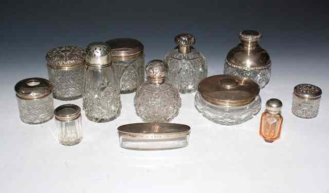 Appraisal: A COLLECTION OF TWELVE SILVER MOUNTED GLASS JARS and scent