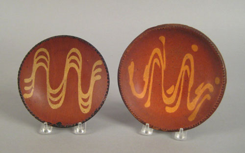 Appraisal: Two Pennsylvania redware pie plates th c with yellow slip