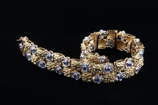 Appraisal: K YELLOW AND WHITE GOLD AND SAPPHIRE FLORAL DESIGN BRACELET