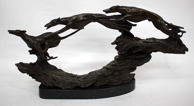 Appraisal: A MODERN CAST BRONZE SCULPTURE OF THREE GREYHOUNDS running across