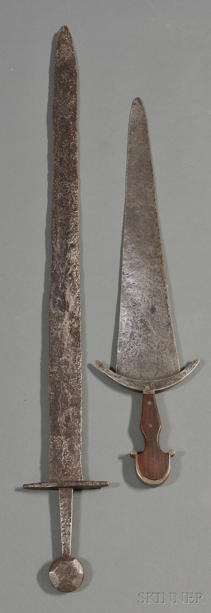 Appraisal: Two Iron Swords one a primitive example with round pommel