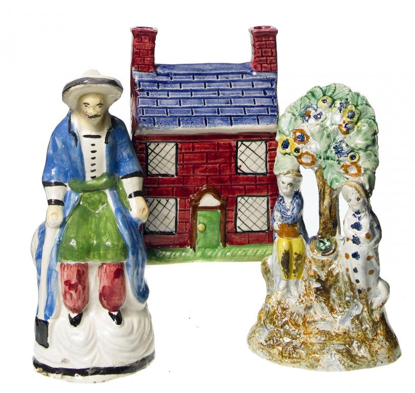 Appraisal: A SCOTTISH EARTHENWARE BANK in the form of a house