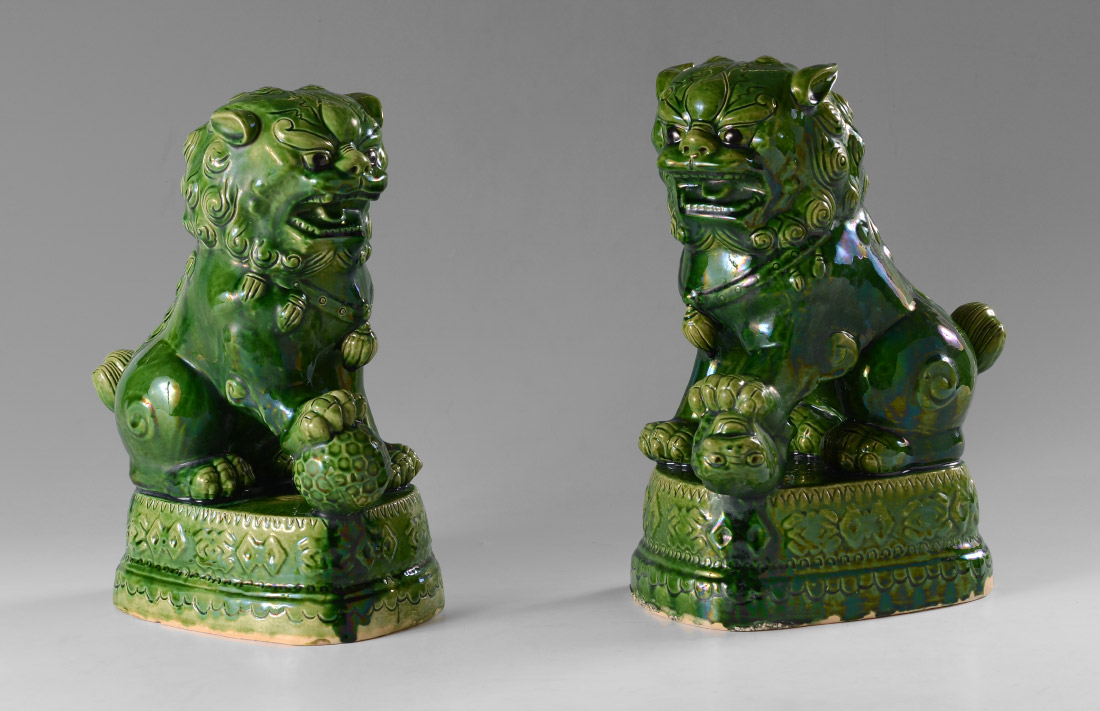 Appraisal: PAIR GREEN GLAZE CERAMIC FOO DOGS th century mottled green