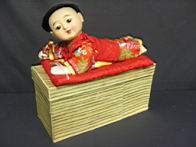 Appraisal: JAPANESE CHILD ON PILLOW MIB Composition with glass eyes nicely