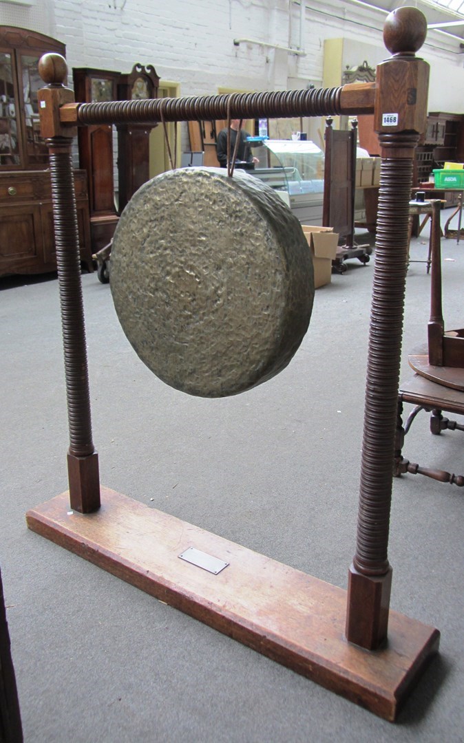 Appraisal: A Burmese oak gong stand with turned frame and brass