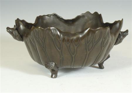 Appraisal: A bronze lotus form dish Probably Japanese with frog handles