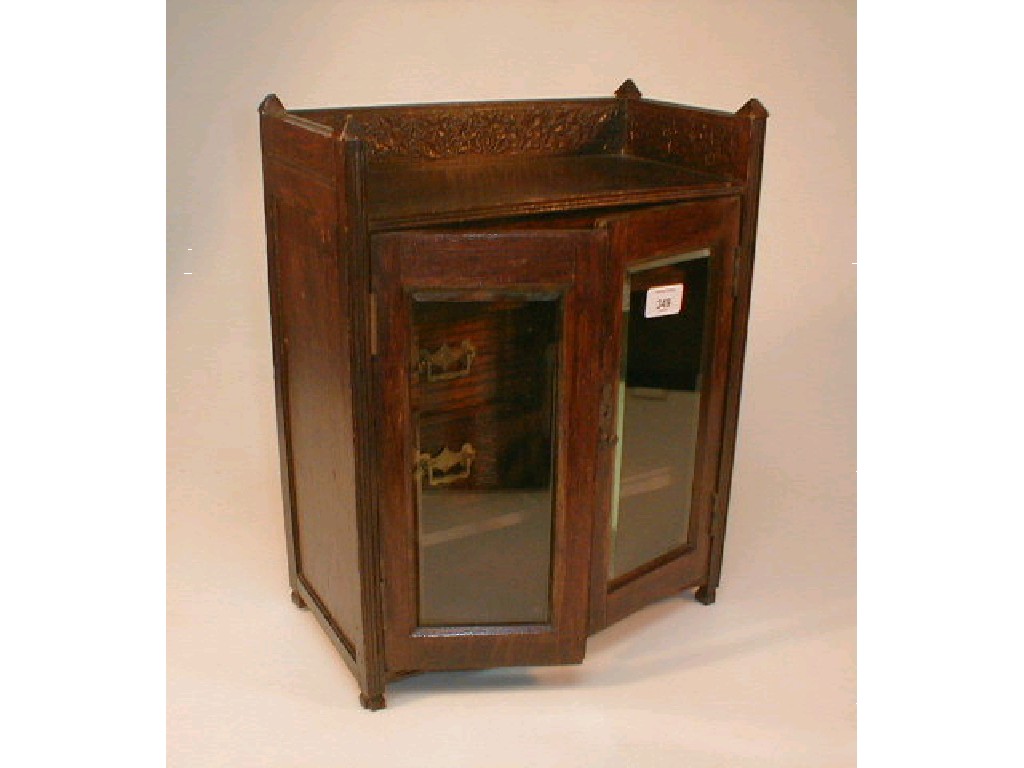 Appraisal: An early thC stained oak smokers cabinet fitted with an