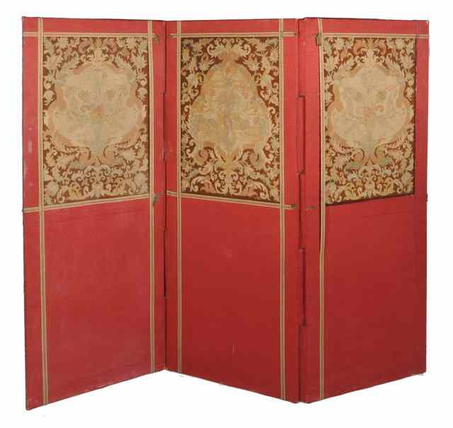 Appraisal: AN ANTIQUE THREE FOLD RED MATERIAL UPHOLSTERED SCREEN with floral