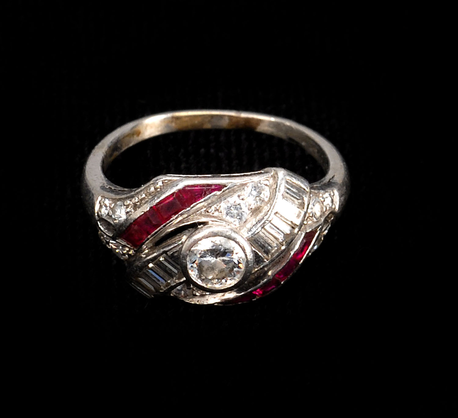 Appraisal: WHITE GOLD RUBY AND DIAMOND RING Central diamond surrounded by