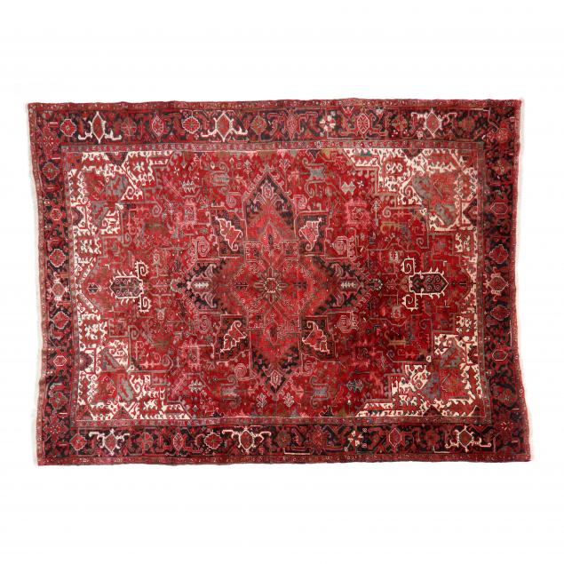 Appraisal: HERIZ CARPET Dark red field center medallion beige spandrels