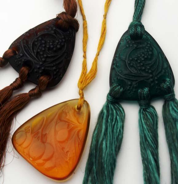 Appraisal: RENE LALIQUE Three pendants Graines in dark green and dark