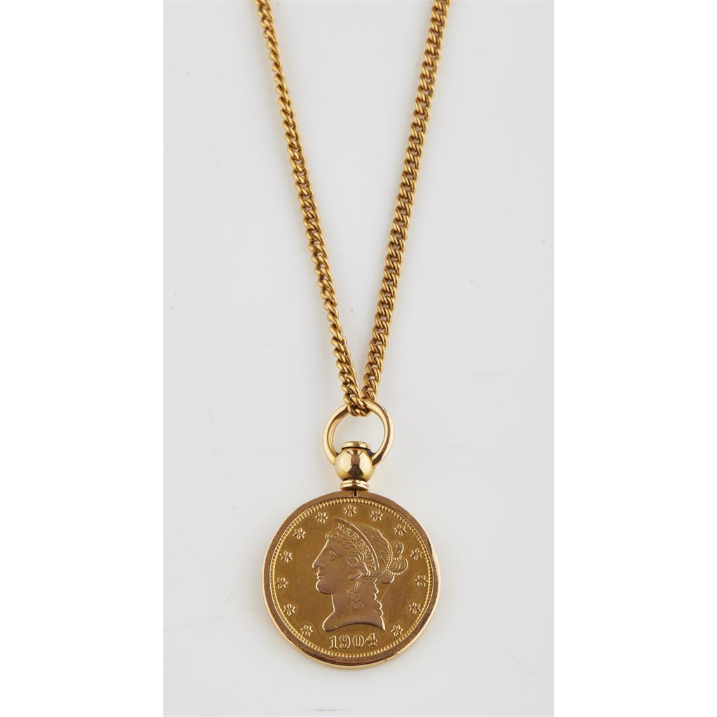 Appraisal: A ten dollar coin in a yellow metal mount to