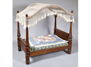 Appraisal: A vintage canopy style doll bed with four finial topped