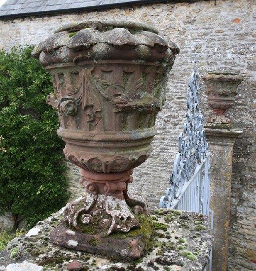 Appraisal: A pair of early th Century red sandstone carved urns