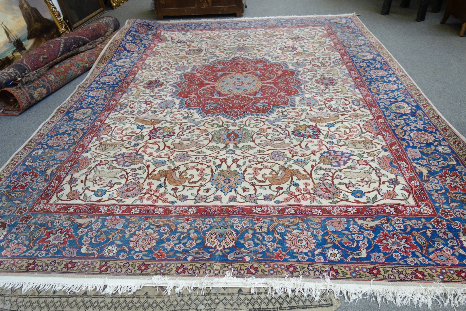 Appraisal: A Tabriz carpet Persian the ivory field with a bold