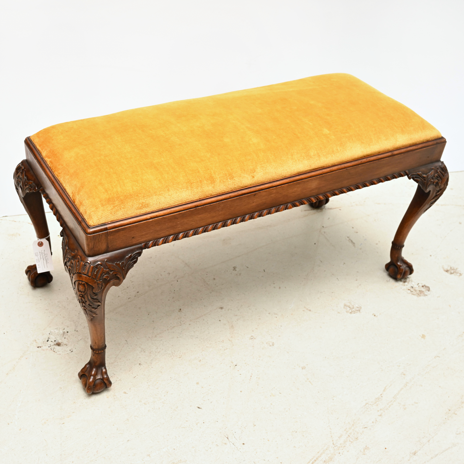 Appraisal: CHIPPENDALE STYLE UPHOLSTERED BENCH th th c with golden yellow