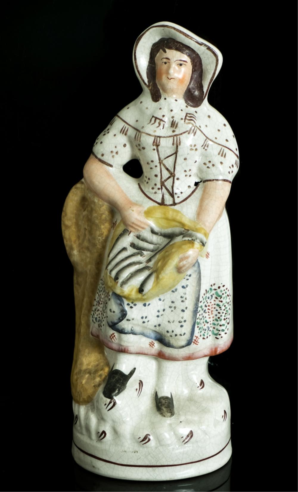 Appraisal: STAFFORDSHIRE FIGURE FEMALE FISHMONGER TH CStaffordshire figure of a female