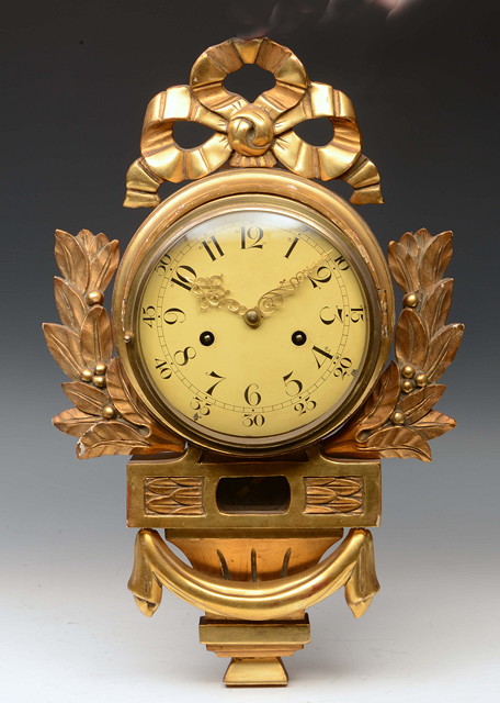 Appraisal: A CONTINENTAL GILTWOOD CARTEL CLOCK having a cream Arabic dial