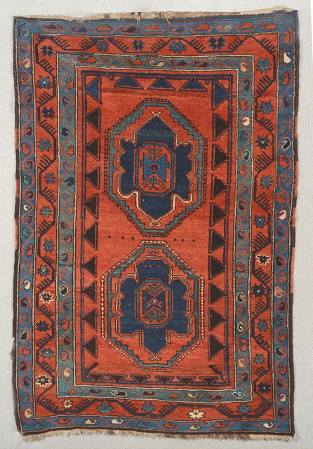 Appraisal: A CAUCASIAN RUST GROUND RUG with two eight sided central