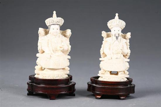 Appraisal: PAIR OF IVORY CARVINGS China Seated emperor and empress on