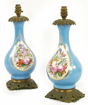 Appraisal: A pair of floral painted porcelain and gilt brass mounted