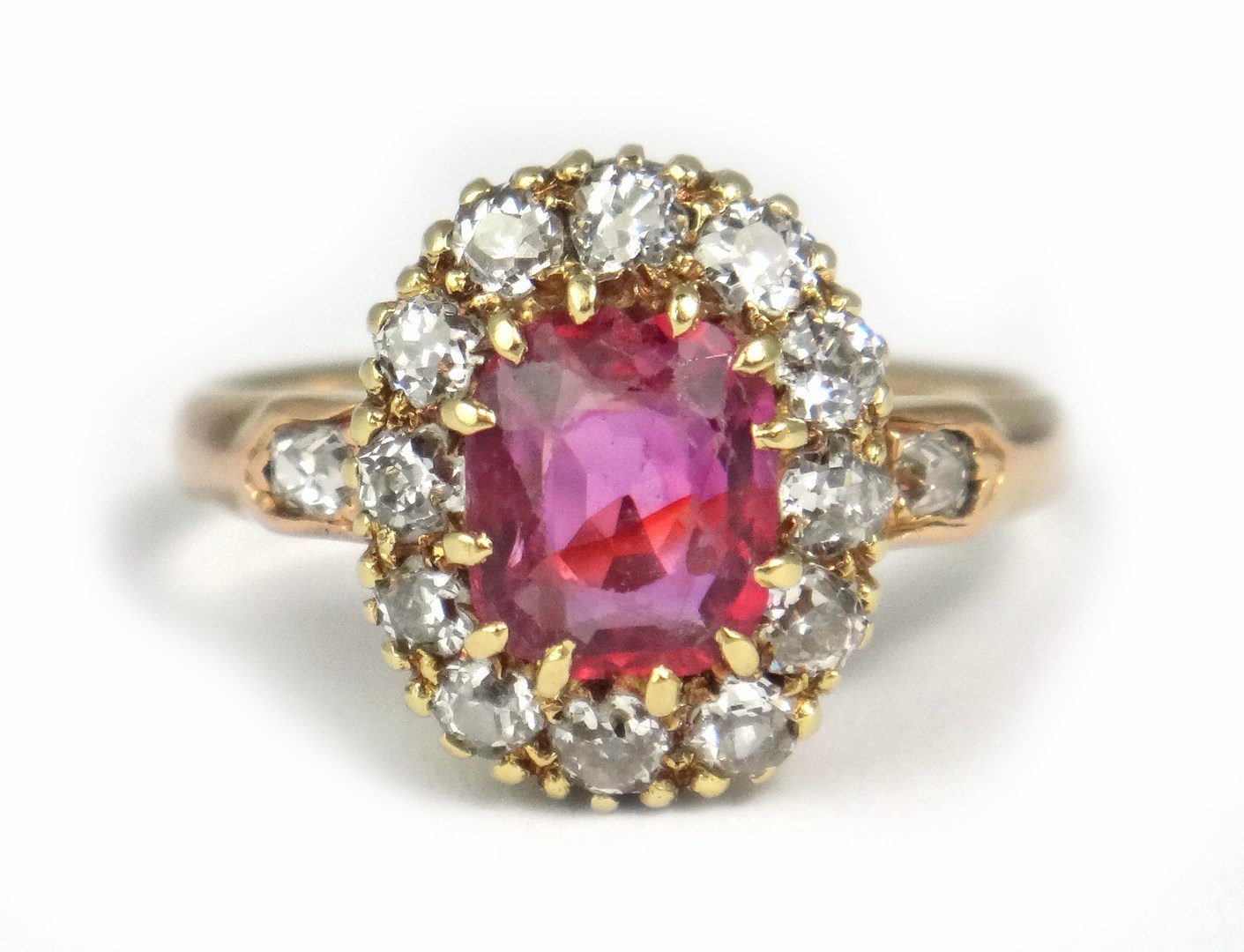 Appraisal: A gold ruby and diamond set cluster ring claw set