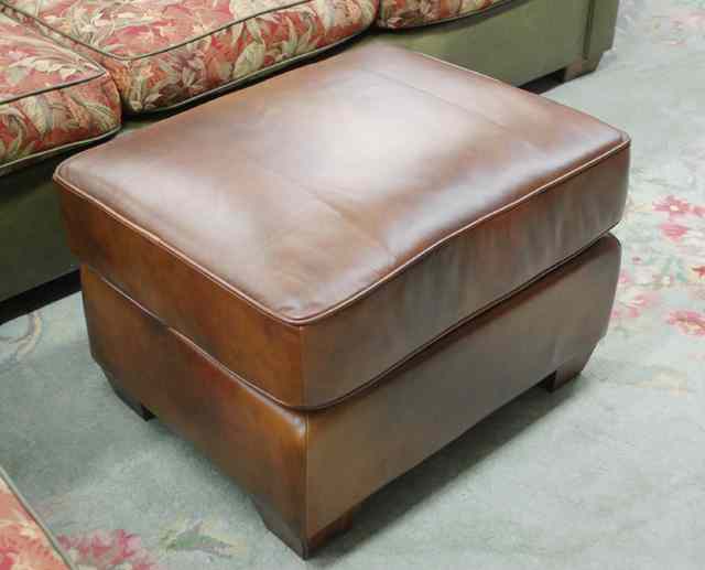 Appraisal: BROWN LEATHER OTTOMAN Howard Miller Signature Home Furnishings by Ty