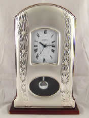 Appraisal: A white metal tests silver faced clock approx cm high