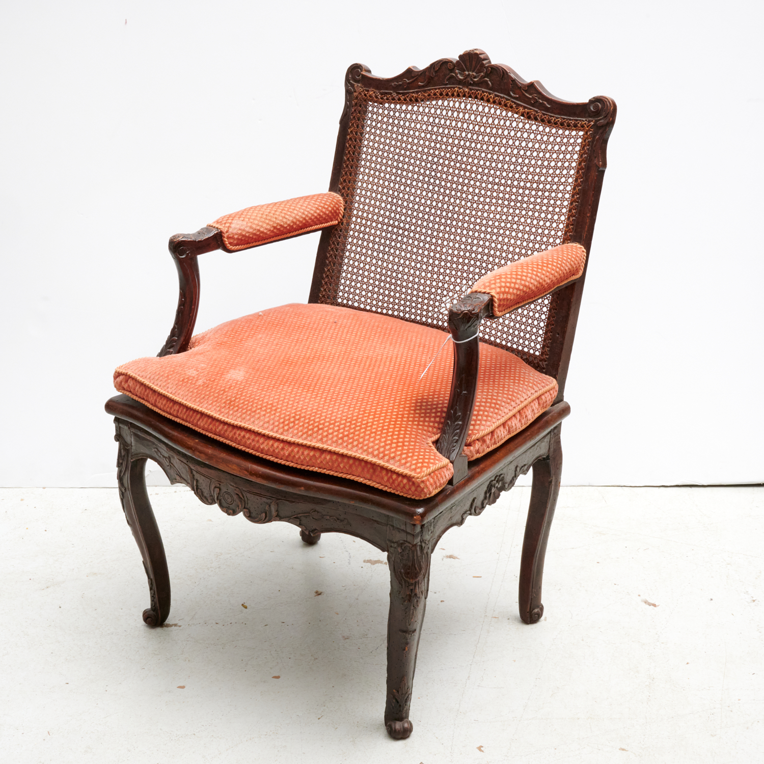 Appraisal: REGENCE CARVED WALNUT FAUTEUIL th c with caned seat and