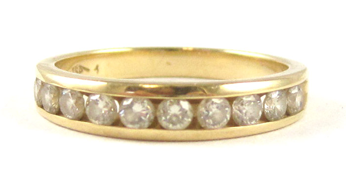 Appraisal: DIAMOND AND FOURTEEN KARAT GOLD RING with ten round-cut channel