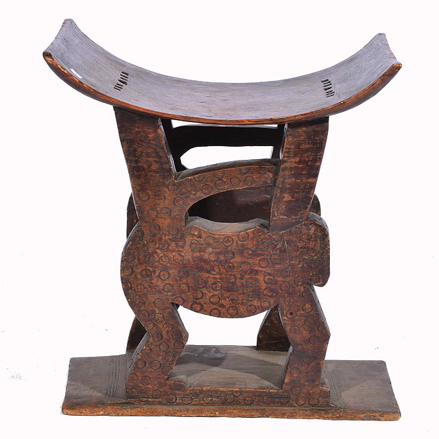 Appraisal: AN ASHANTI CARVED WOODEN STOOL with dished top and standing