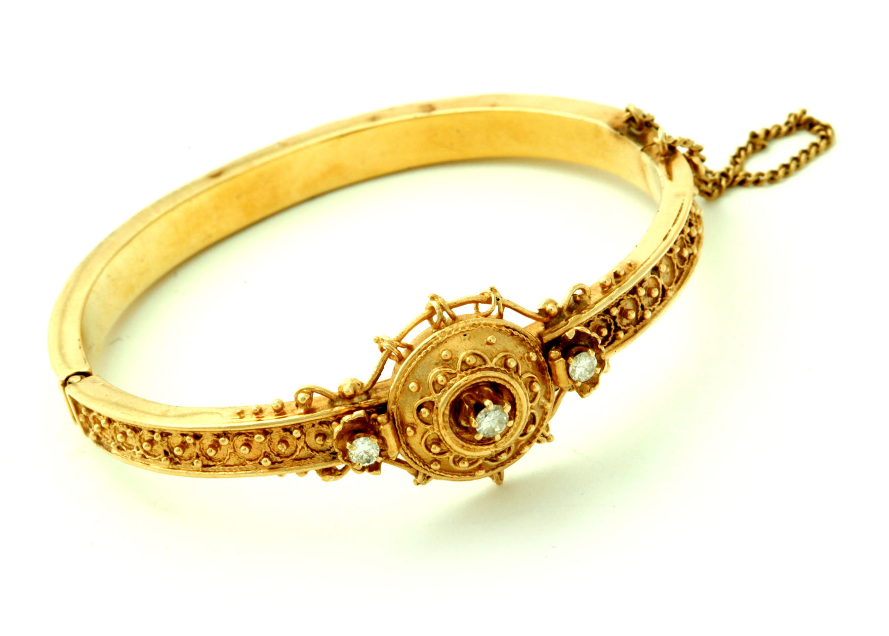 Appraisal: ETRUSCAN REVIVAL GOLD AND DIAMOND BANGLE Twentieth century Heavy hollow