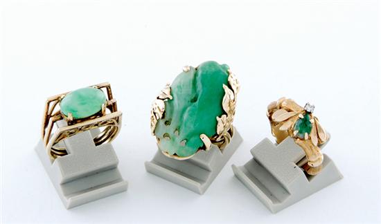 Appraisal: Jade rings oval carved jade fruit x mm set in