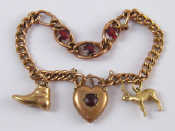 Appraisal: A yellow metal charm bracelet the bracelet and two charms