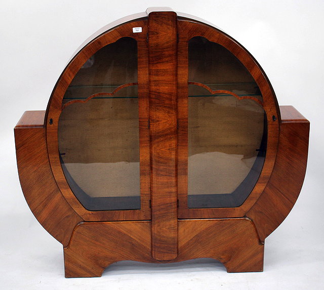 Appraisal: AN ART DECO WALNUT DISPLAY CABINET with glazed doors enclosing