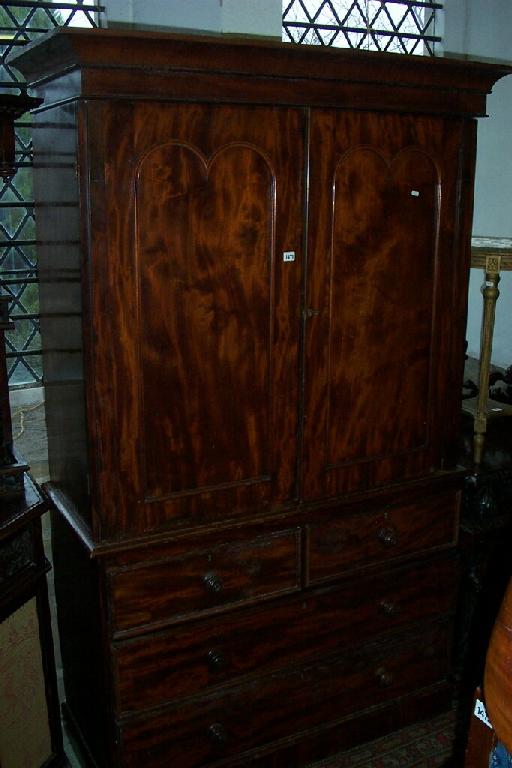 Appraisal: A Victorian mahogany linen press the lower section enclosed by