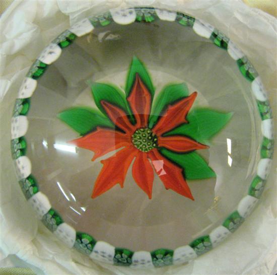 Appraisal: Perthshire glass Christmas paperweight containing a poinsettia on a clear