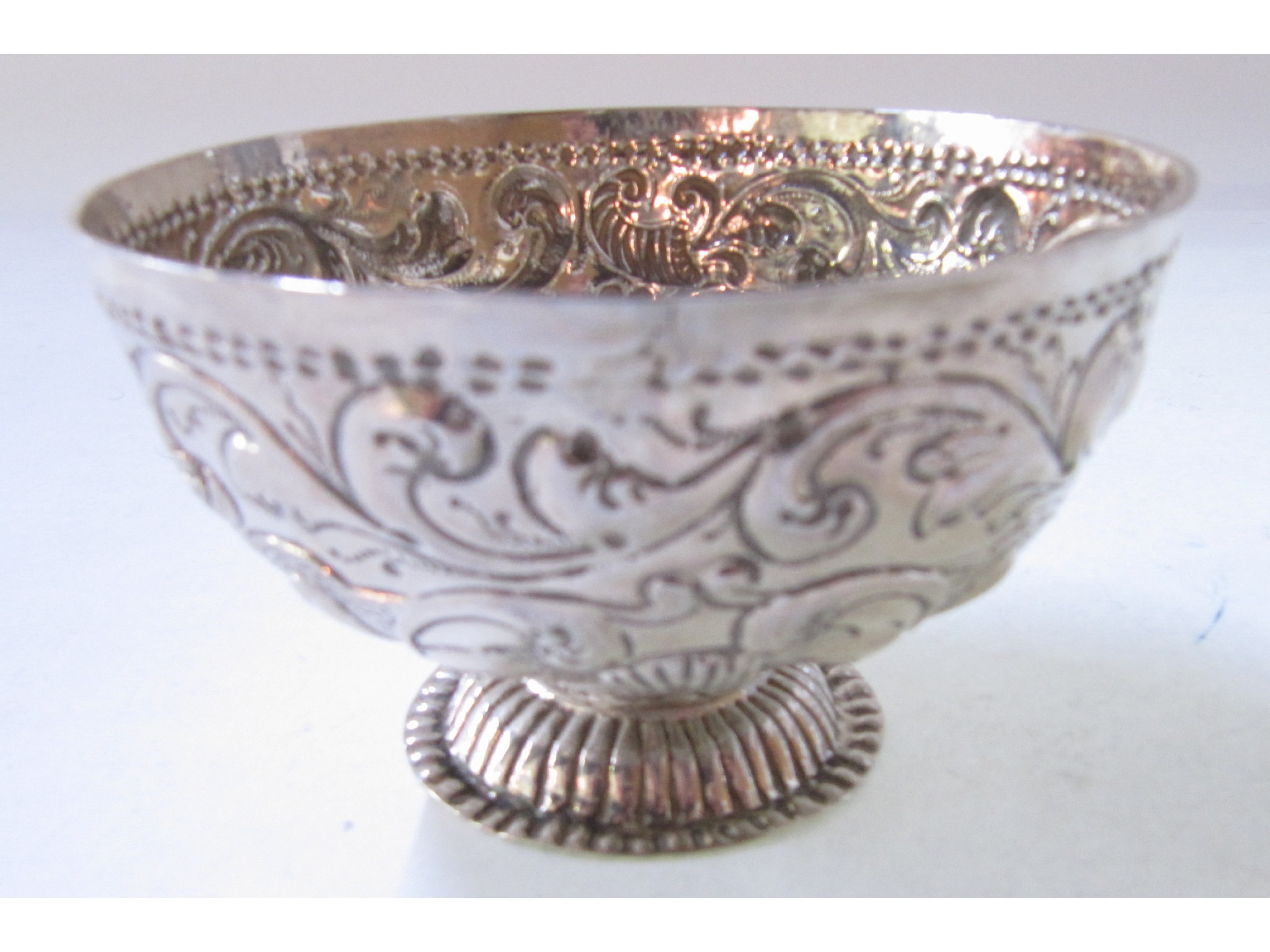 Appraisal: An embossed white metal bowl