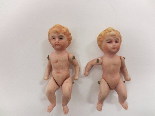 Appraisal: A pair of small bisque dolls with moulded hair and