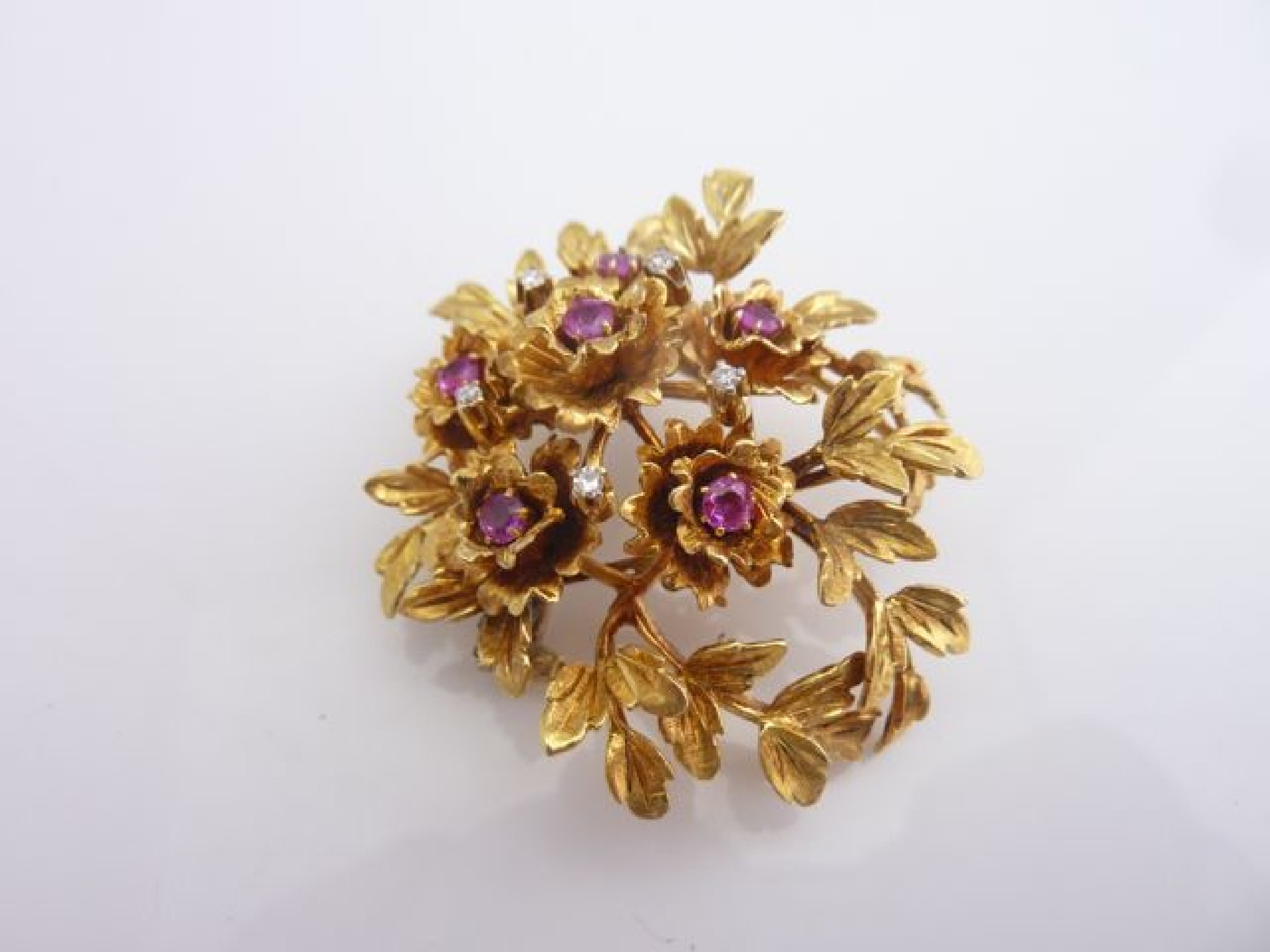 Appraisal: A ruby and diamond spray brooch composed of leaves and