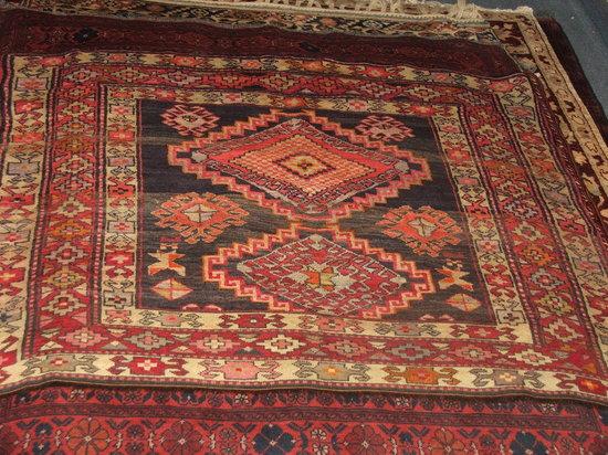 Appraisal: A TURKOMAN WINE GROUND RUG - decorated a central medallion